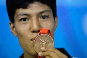 Hazara Star Rohullah Nikpai kisses his bronze medal at the Beijing 2008 Olympics Wednesday, Aug. 20, 2008.